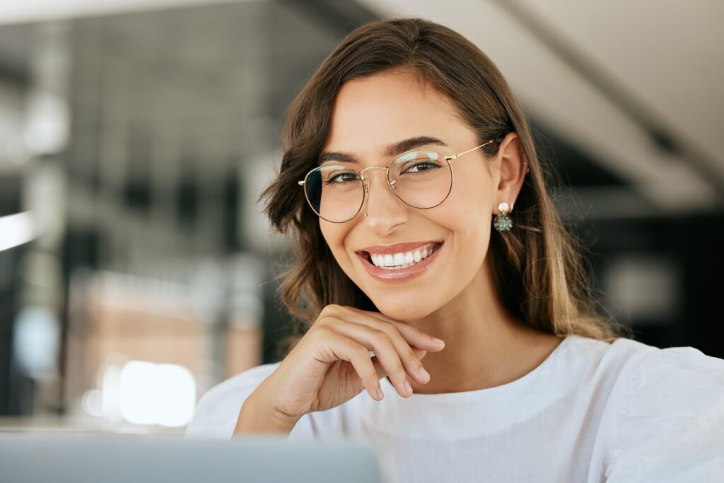Creative, woman and portrait smile with glasses for vision, career ambition or success at the offic
